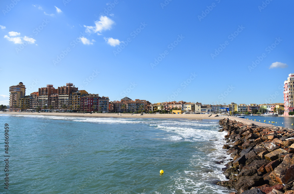 Fototapeta premium Coastline Alboraya beach with colourful house and building in Port Saplaya. Travel on touristic famous and popular Beaches of Valencia with unique landscape on Mediterranean Sea.