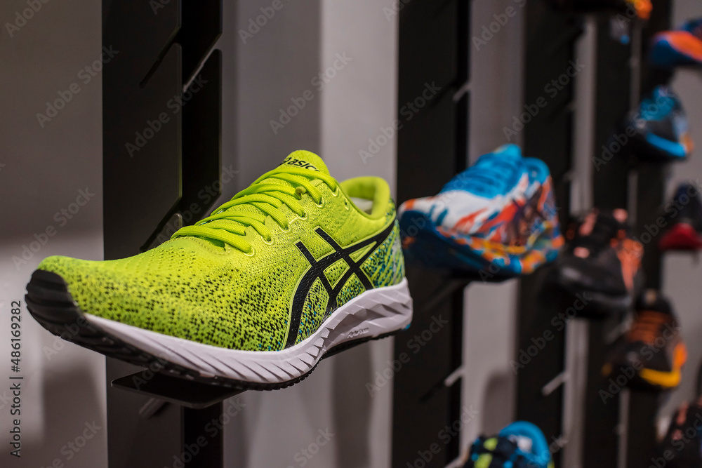 Manila, Philippines - Feb 2022: Asics running shoes for display on a wall  rack at a local boutique store. Stock Photo | Adobe Stock