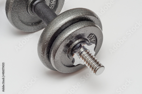 collapsible metal dumbbells for sports at home. White background.