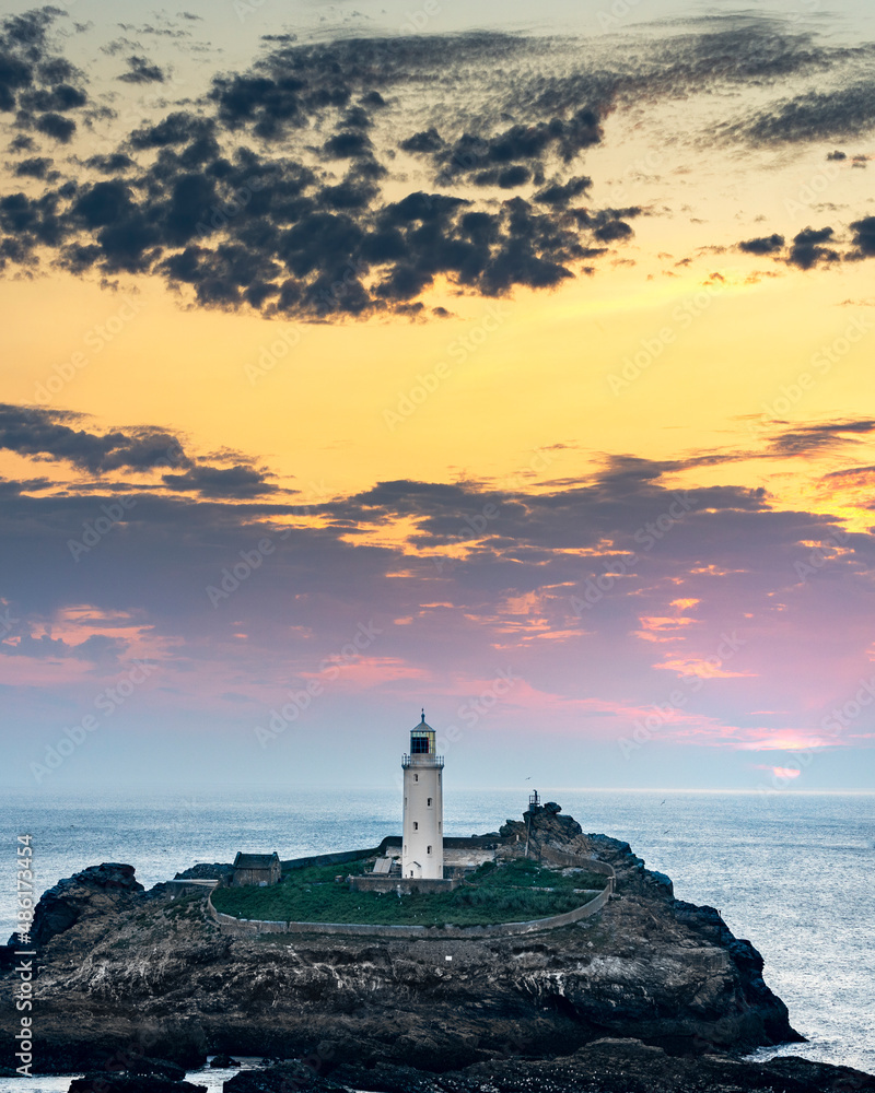 The Lighthouse on Godrevy Island,as the sun sets below dramatic golden sky,Corwall,England,UK.