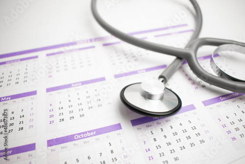 Health care and medical exam schedule calendar, reminder or appointment concept, doctor's stethoscope
