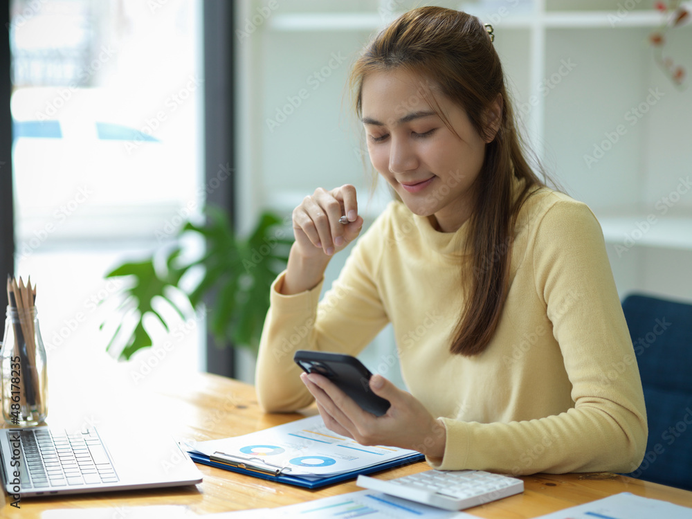 Businesswoman or marketing officer using a modern smartphone. Businesswoman or marketing officer using a modern smartphone.