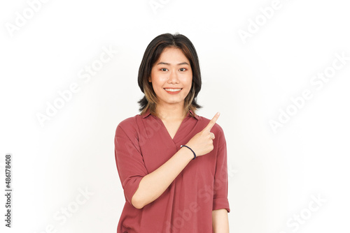 Showing Product and Pointing Side Of Beautiful Asian Woman Isolated On White Background © Sino Images Studio