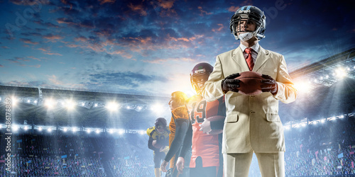 Businessman acting as american football players . Mixed media © Sergey Nivens