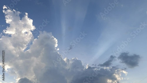 Dramatic rain clouds n sun light ray or sunbeam on blue sky