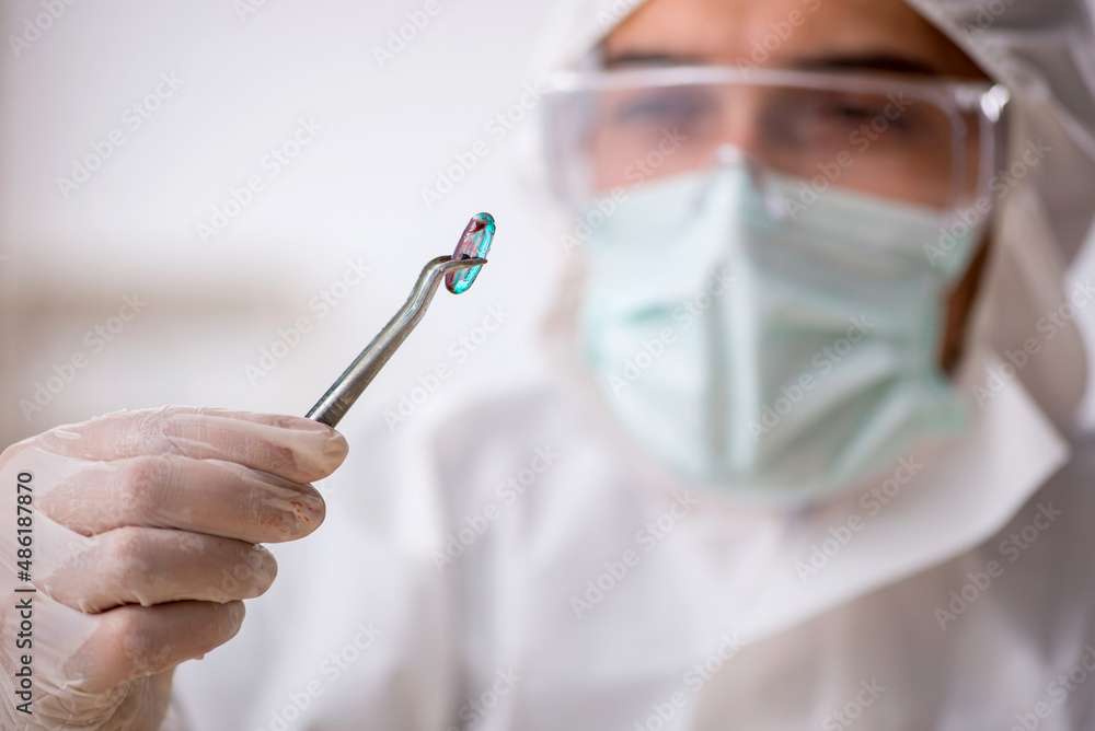 Young male chemist in drugs synthesis concept Young male chemist in drugs synthesis concept