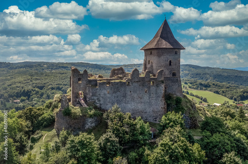 Aerial view of Somosko medieval castle between Slovakia and Hungary on a hilltop with triangle shape and three round towers  one cowered with a roof