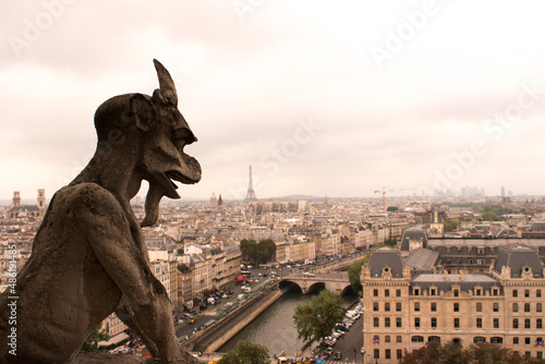 Gargoyle at Cathedra; Notre-Dame Paris with view of Eiffel Tower