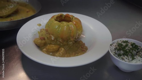 Assembling the gourmet dish Camarão na Moranga photo