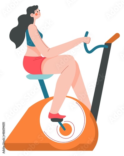 Woman working out in gym using bike for cardio
