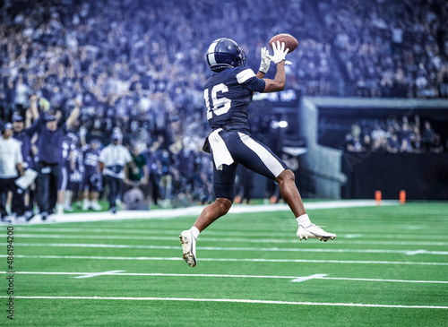 American Football Player catching a pass during a game. Composite photo photo
