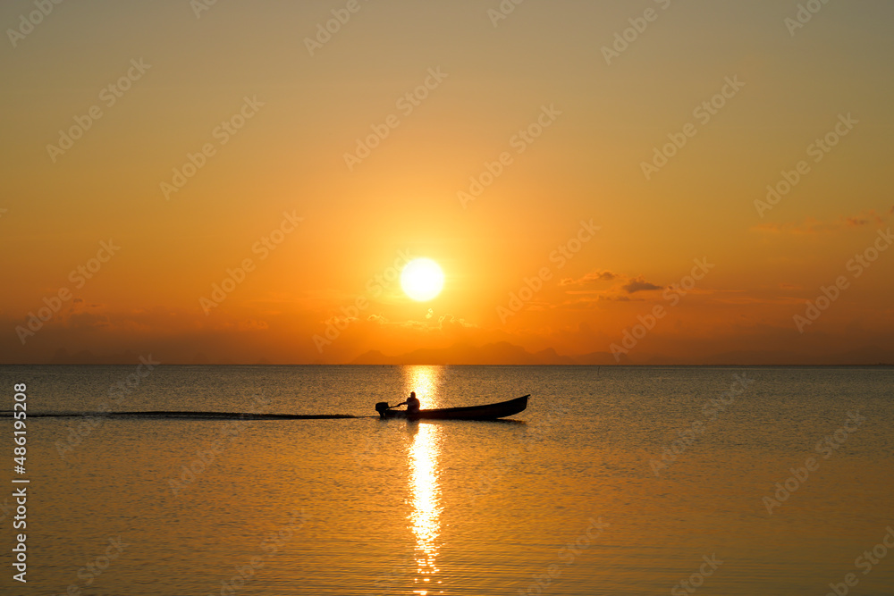 silhouette of a fishing boat in the lake