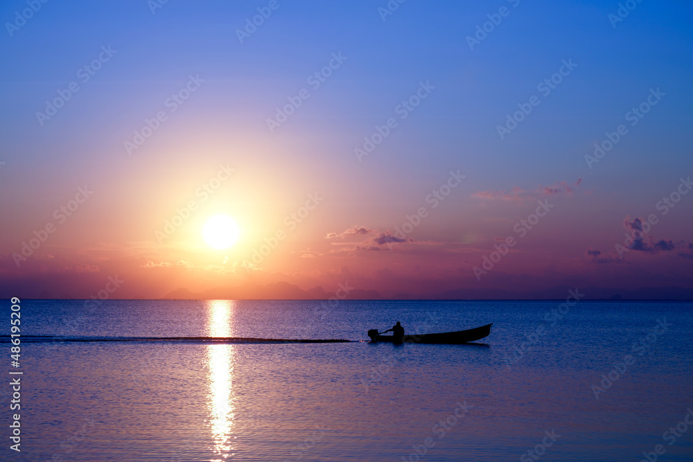 silhouette of a fishing boat in the lake