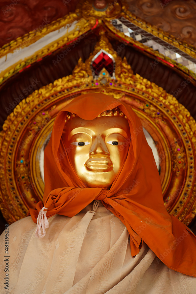 Buddha statue with veil with blur background.