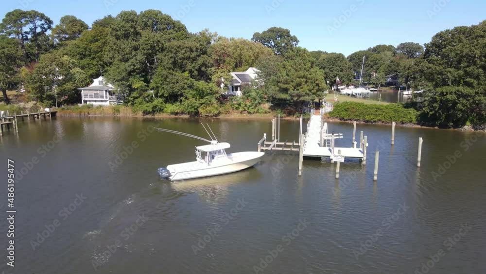 A boat docking off of the Chesapeake Bay on a nice bright sunny day.