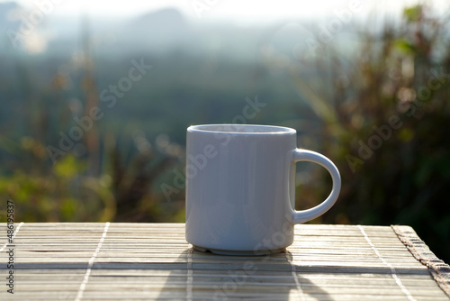 Coffee mug at sunset with blurred background