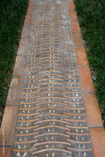 Chinese brick walkway with grass on the sides