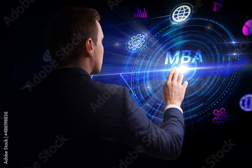 Business, Technology, Internet and network concept. Young businessman working on a virtual screen of the future and sees the inscription: MBA