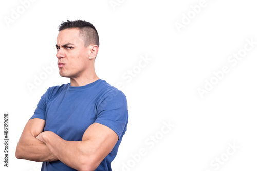 Man turning aside with arms crossed and a doubtful expression