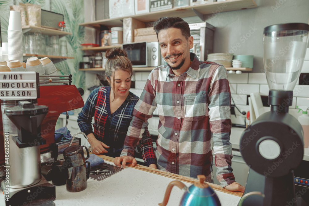 Fototapeta premium Portrait of happy couple working as barista together in modern cafe