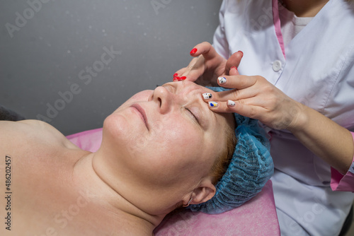  woman in a professional beauty spa during a facial massage procedure © Tania