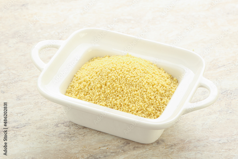 Raw couscous in the bowl Raw couscous in the bowl