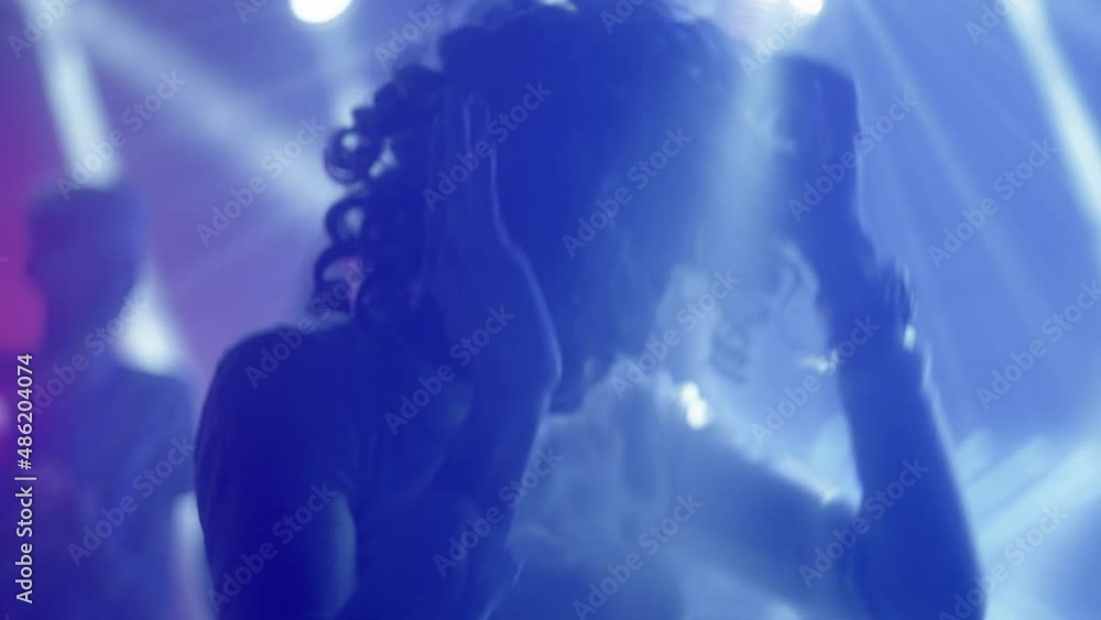 Woman dancing at party. Living in beats, expressing emotions. Nightlife, modern music and entertainment concept. Woman dancing at party. Living in beats, expressing emotions. Nightlife, modern music and entertainment concept.