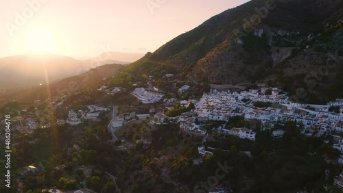 Spanish town of Mijas in Andalusia on a steep mountainside at sunset.
