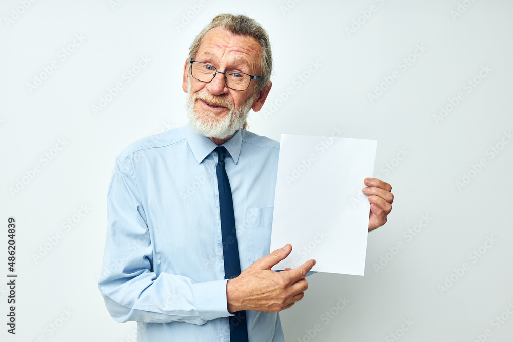 Portrait of happy senior man in a shirt with a tie copy-space sheet of paper cropped view Portrait of happy senior man in a shirt with a tie copy-space sheet of paper cropped view