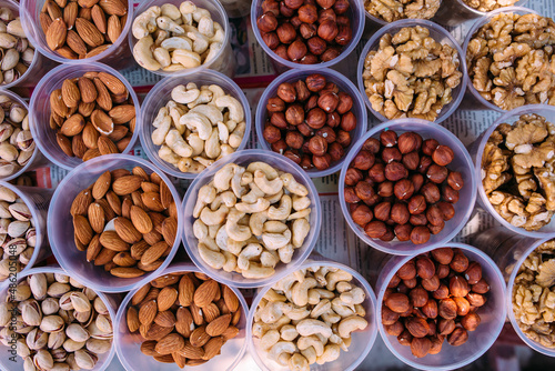 variety of nuts in cups on the market in portions
