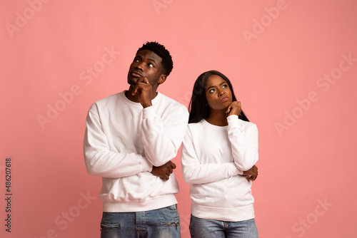 Confused african american man and woman looking aside