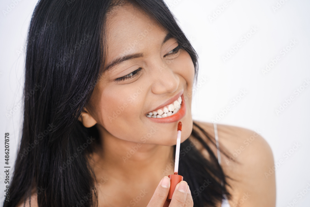 beautiful woman applying lipstick on her lips beautiful woman applying lipstick on her lips