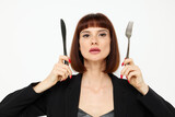 portrait of a woman short-haired in a black jacket cutlery isolated background