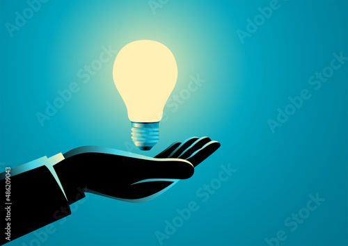 Businessman hand holding a light bulb