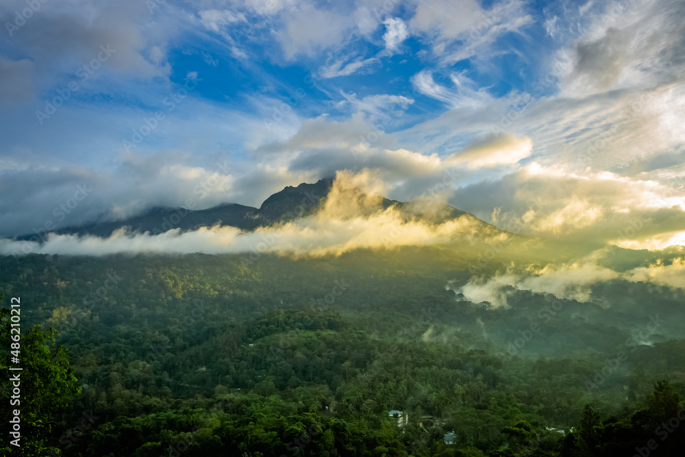 Beautiful mountain landscape with Sunrise and passing clouds. Munnar, Kerala, India