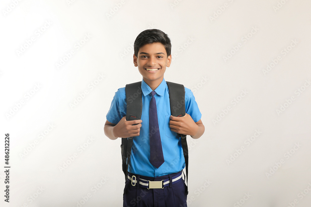 Indian school boy standing on white background. Indian school boy standing on white background.