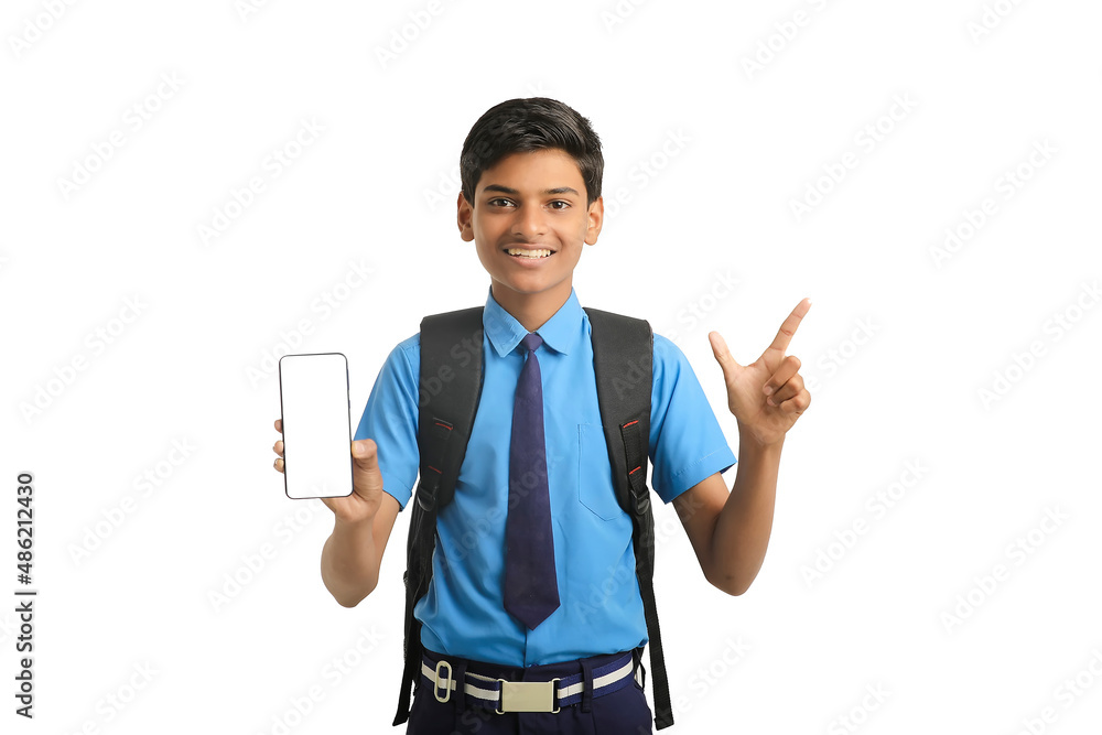 technology concept: Cute indian little school boy showing smartphone technology concept: Cute indian little school boy showing smartphone
