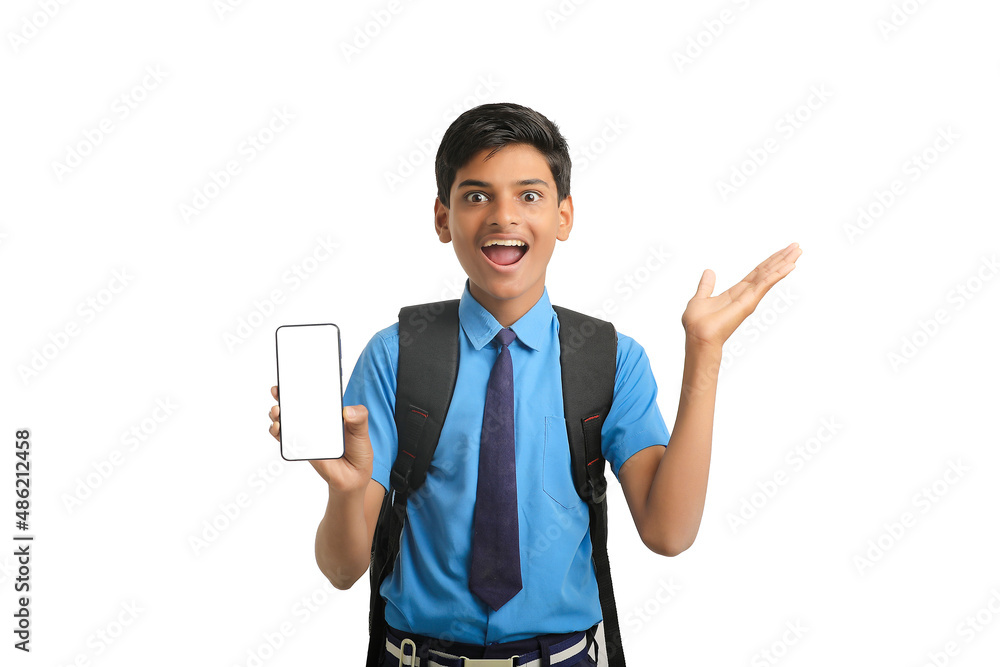 technology concept: Cute indian little school boy showing smartphone technology concept: Cute indian little school boy showing smartphone