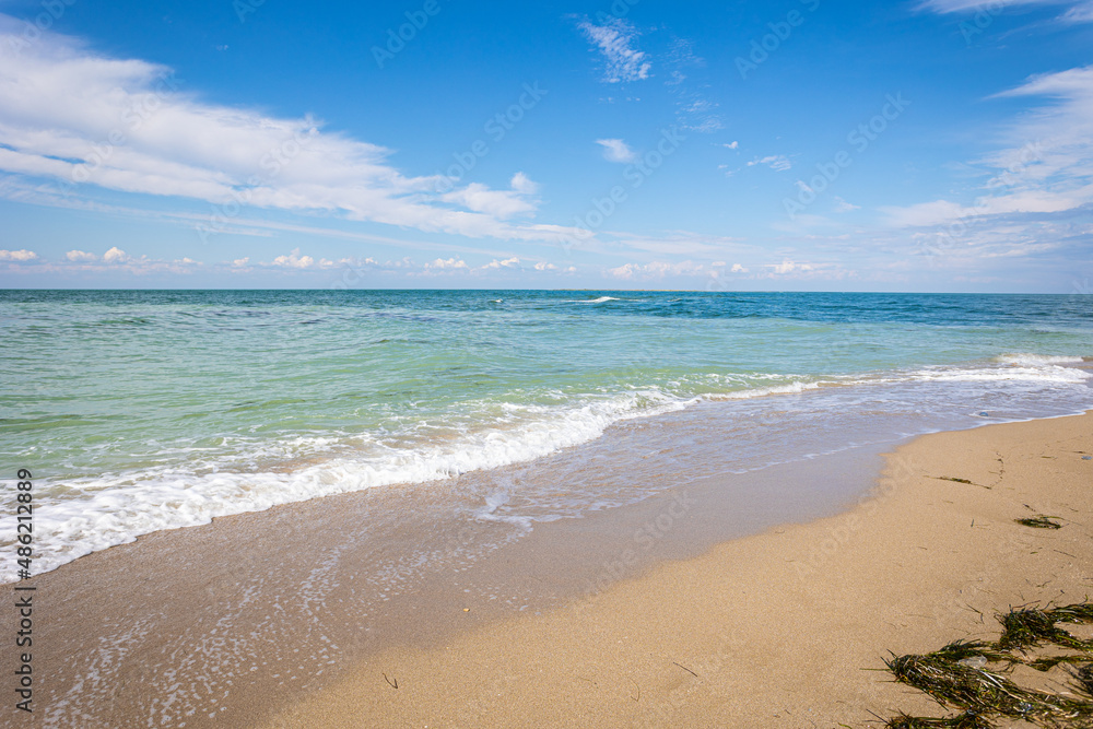 Beautiful bright colorful tropical summer background. Soft turquoise blue ocean wave on golden sandy beach.