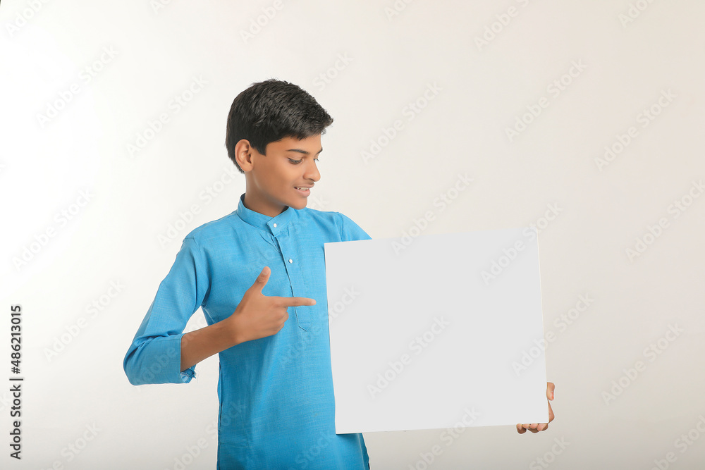 Indian little child in traditional wear and showing white board. Indian little child in traditional wear and showing white board.