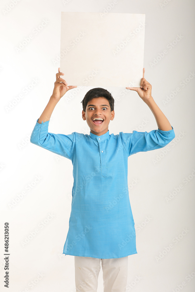 Indian little child in traditional wear and showing white board. Indian little child in traditional wear and showing white board.