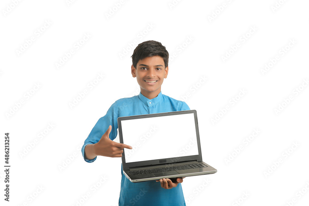 Indian child wearing traditional cloth and showing laptop screen Indian child wearing traditional cloth and showing laptop screen