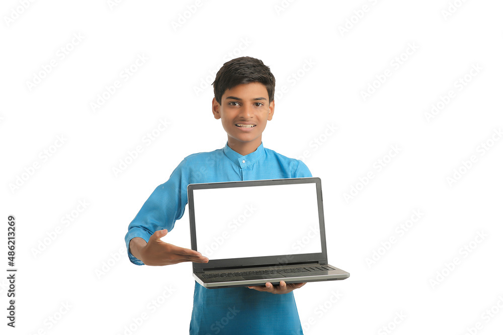 Indian child wearing traditional cloth and showing laptop screen Indian child wearing traditional cloth and showing laptop screen