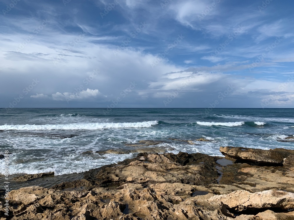 Rocky coastline, vivid sea and beautiful bright sky 