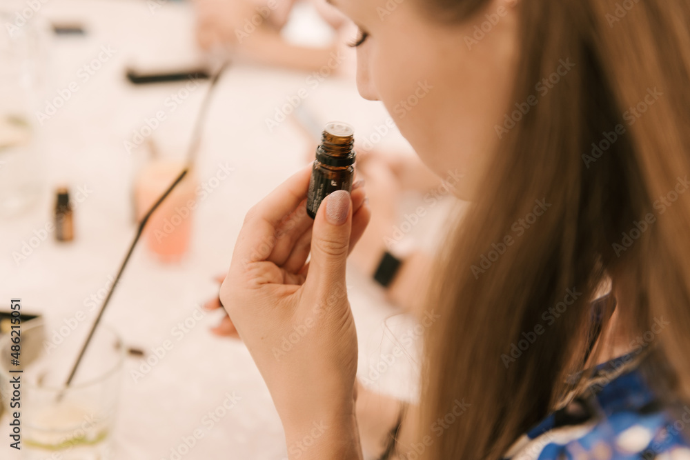 A box with doterra essential oil, a jar of oil in women's hands