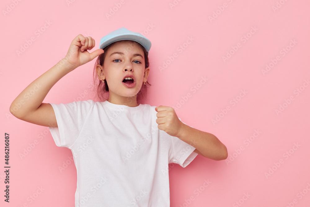 Portrait of happy smiling child girl posing white tshirt emotion pink background Portrait of happy smiling child girl posing white tshirt emotion pink background