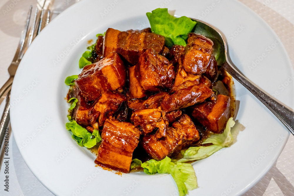 Chinese Deep Fried Pork Chunks With Sweet and Sour Sauce, Served on Lettuce Leaves. High quality photo Chinese Deep Fried Pork Chunks With Sweet and Sour Sauce, Served on Lettuce Leaves. High quality photo