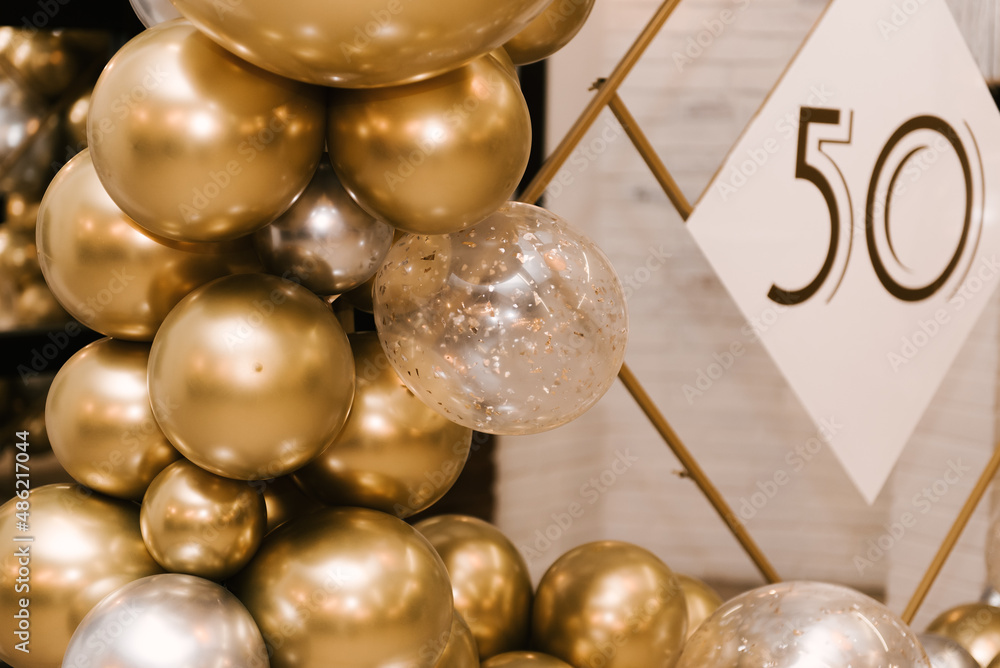 The round photo zone is decorated with gold and silver balls for the 50th birthday, the work of an aerodesigner The round photo zone is decorated with gold and silver balls for the 50th birthday, the work of an aerodesigner
