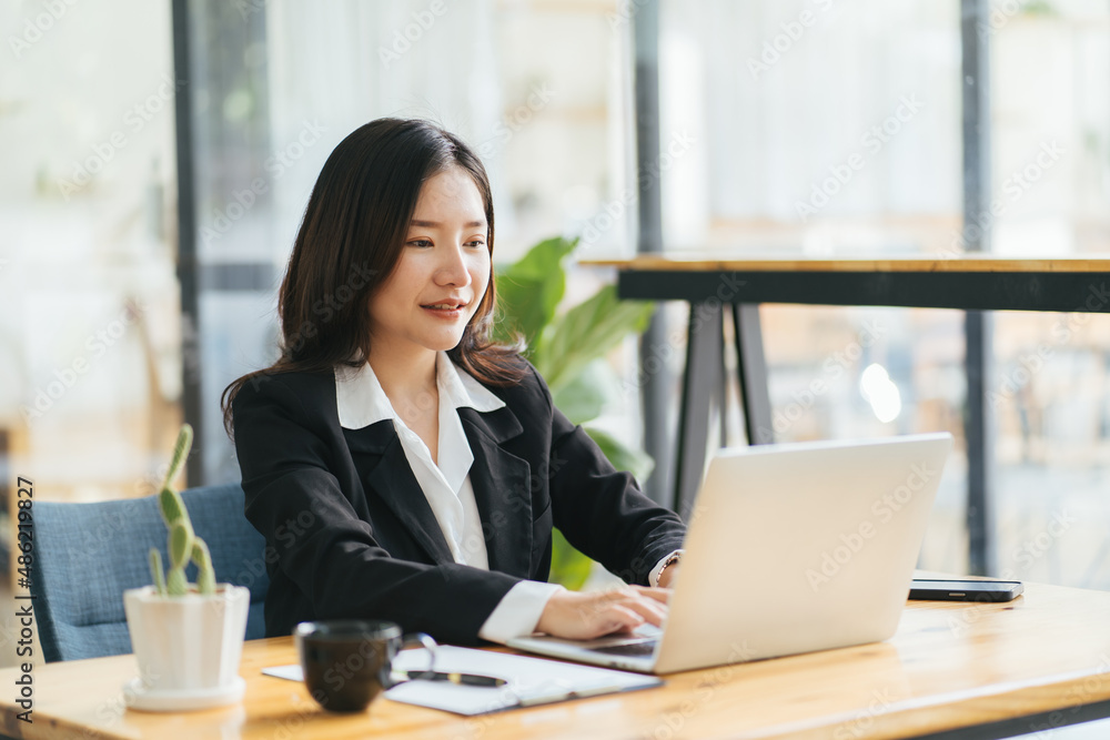 Photo of young cheerful positive good mood smiling happy businesswoman working in computer at office workstation Photo of young cheerful positive good mood smiling happy businesswoman working in computer at office workstation