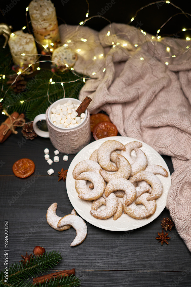 Plate of Traditional German or Austrian Vanillekipferl vanilla kipferl cookies and decorations Plate of Traditional German or Austrian Vanillekipferl vanilla kipferl cookies and decorations